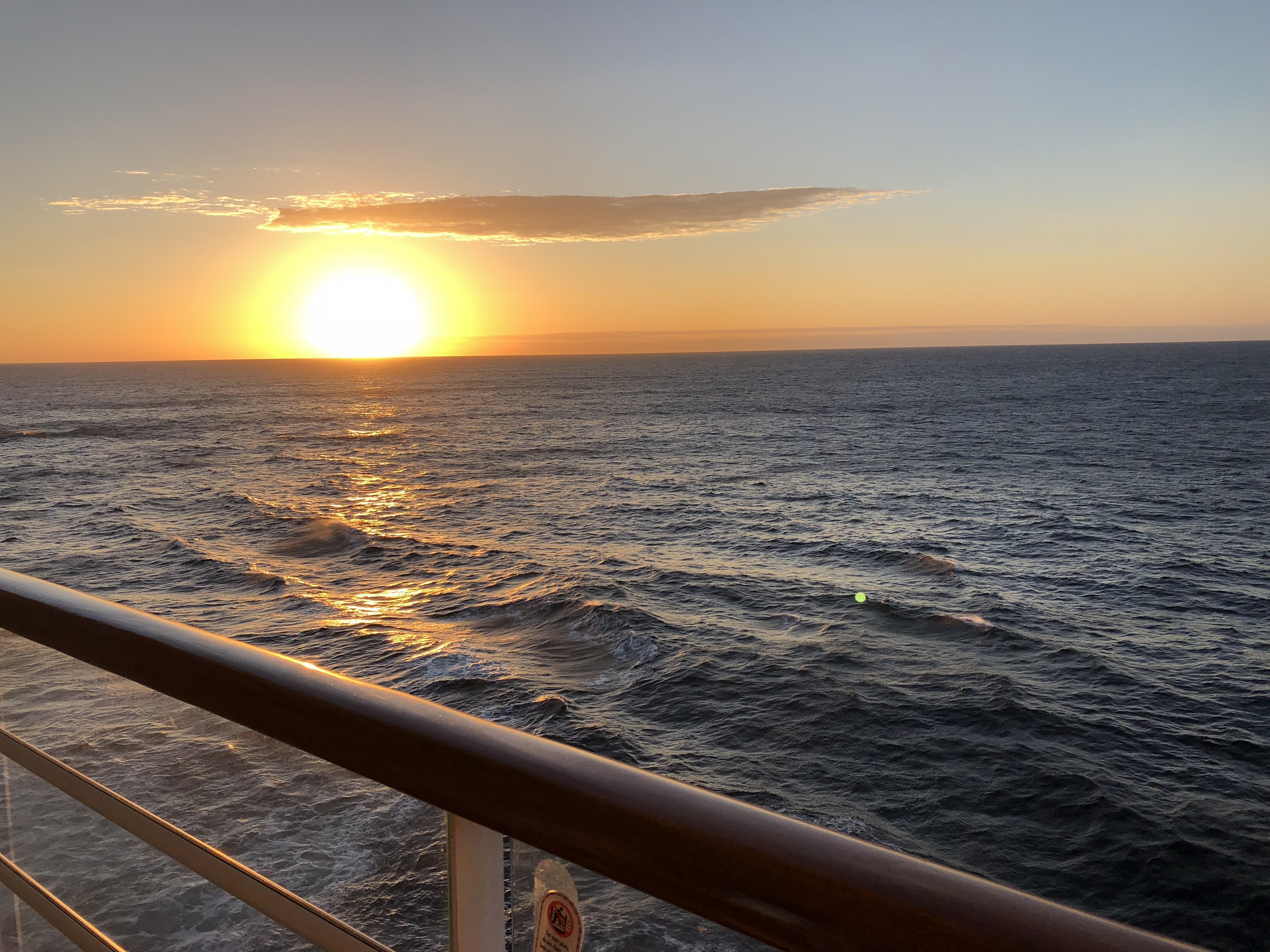 A sunset seen from the verandah of a stateroom on a Disney Cruise ship